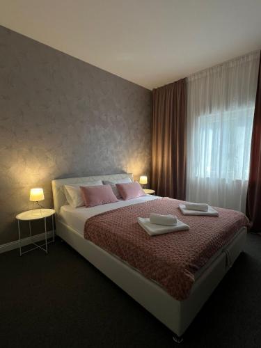 Postel nebo postele na pokoji v ubytování Apartments Aureus