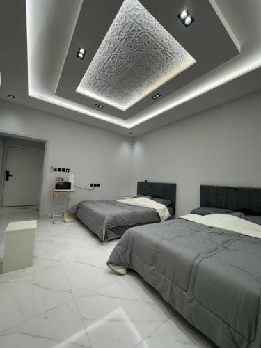 Ένα ή περισσότερα κρεβάτια σε δωμάτιο στο شقق فندقية فاخرة البيت العتيق مكة