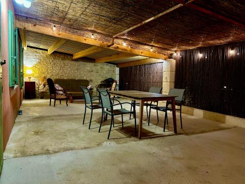 a dining room with a table and chairs at Domaine Plan des Devens in Roussillon