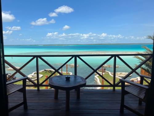 a balcony with a view of the ocean at Blue Caribe Bacalar Front Lagoon in Bacalar