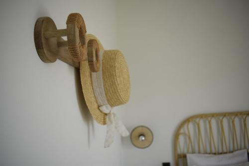 a pair of towels hanging on a wall at Kikkos Village House in Néa Koróni