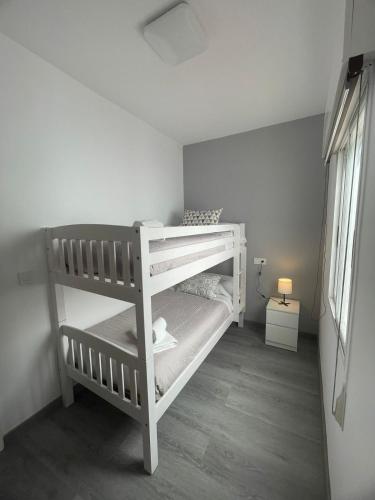 a white bunk bed in a white room at Casa do Sol in O Grove