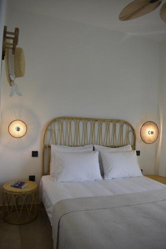 a bedroom with a large bed with white pillows at Kikkos Village House in Néa Koróni