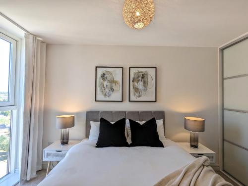 a bedroom with a large white bed with two lamps at Number 43 Elite Apartment - Top Floor - Free Parking in Hemel Hempstead