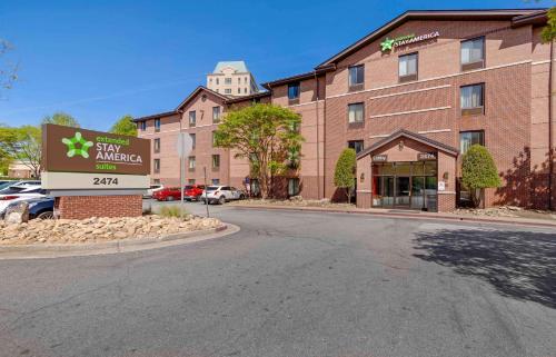 a building with a sign in front of a street at Extended Stay America Select Suites - Atlanta - Vinings in Atlanta