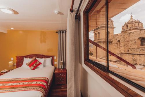 Säng eller sängar i ett rum på Quechua Hotel Cusco