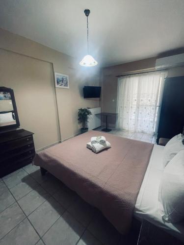 a bedroom with a bed with a towel on it at Klapidis apartments in Kriopigi