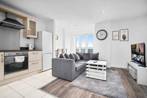 a living room with a couch and a kitchen at 2 Bedroom Apartment With Balcony - FREE PARKING in Birmingham