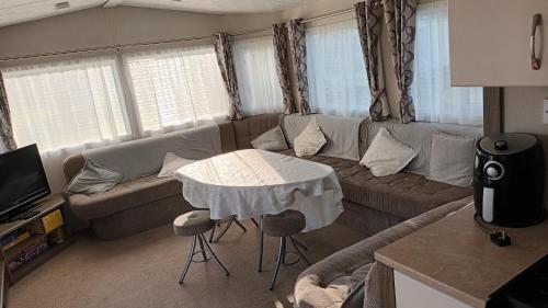 a living room with a couch and a table at Butlins minehead caravan 120 River cove passes included in Minehead