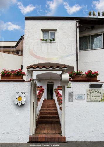 a white building with stairs and flowers on it at RAMO FIORITO in Sant’Agata Li Battiati 