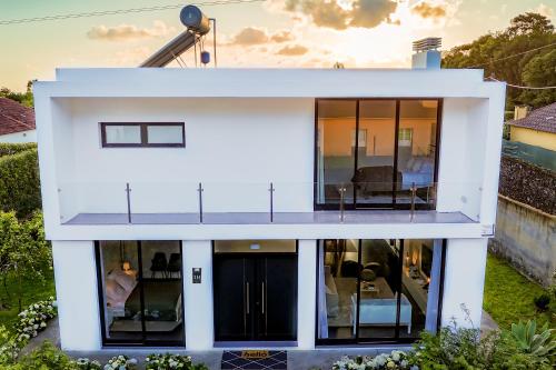a white house with a lot of windows at Cristy's Place in Cabouco