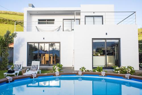 a house with a swimming pool in front of it at Cristy's Place in Cabouco