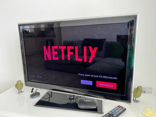 a television with the word netflix on the screen at Modern 2-Bedroom Apartment in Bristol
