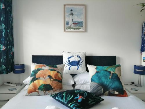a bedroom with a bed with pillows and a lighthouse at The Blue Crab in Bournemouth in Bournemouth