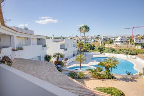 a view of the pool from the balcony of a building at Renovated 2BD AC Wi-Fi Pool Beach 350m in Porches