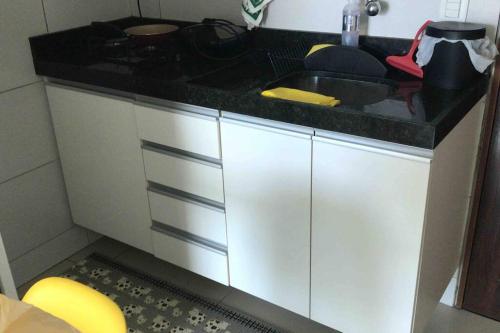 a kitchen with a sink and a counter top at Apartamento Dimensional Home Service - Manaíra in João Pessoa