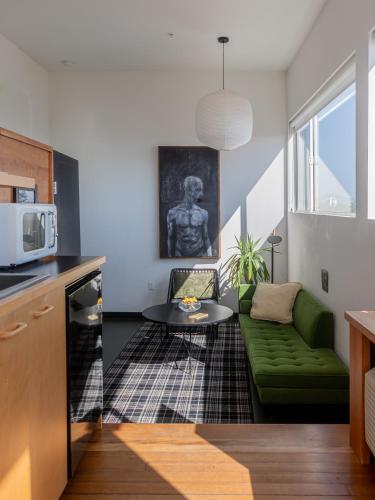 a living room with a green couch and a table at Abpopa Hillcrest in San Diego
