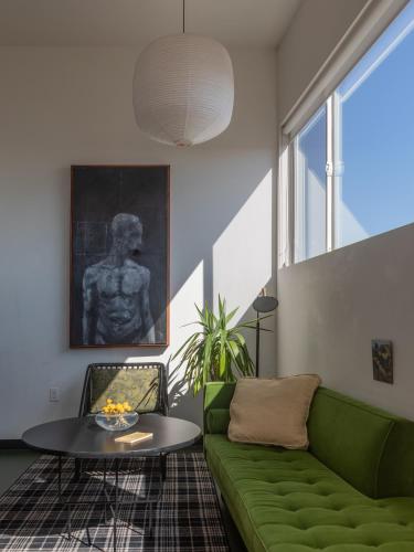 a living room with a green couch and a table at Abpopa Hillcrest in San Diego