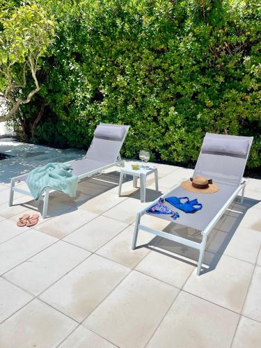 two chairs and a table on a patio at Casa dos Trevos, 5 Bedroom Villa with Pool in Lagos