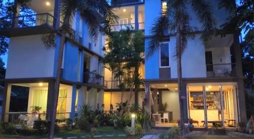 an exterior view of a building at night at White@Sea Resort in Ban Phe