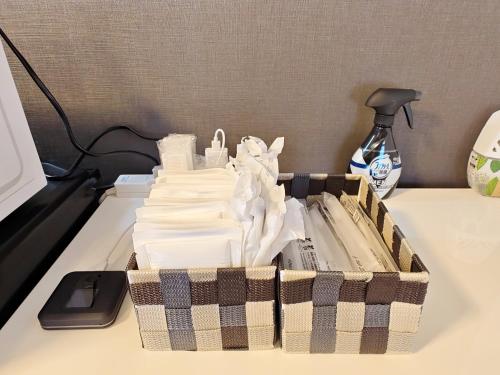 a basket of papers sitting on a desk at 清潔#快適#広々なんば駅徒歩8分#9名宿泊可#Wi-Fiswitch#大画面TV in Osaka