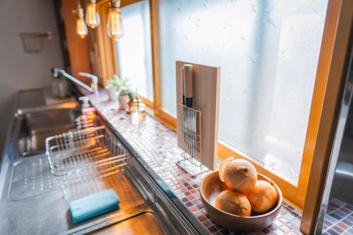 a bowl of bread sitting on a counter in a kitchen at comma, nagayama in Asahikawa