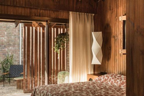 a bedroom with a bed and a window at Sea Sea Hotel in Crescent Head