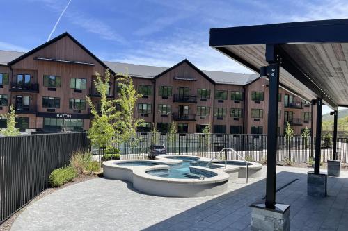 a building with a hot tub in front of a building at Black Rock Ridge 14457 by Moose Management in Kamas