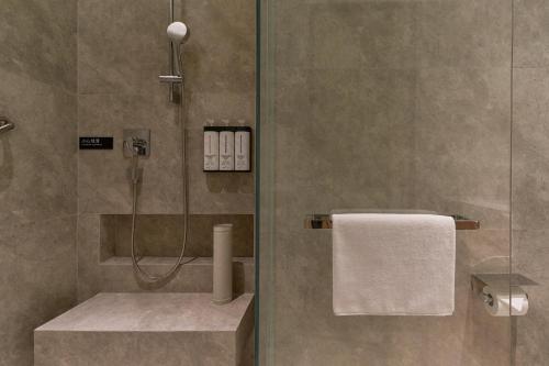 a bathroom with a shower with a glass door at Hyatt Place Nantong Xinghu City Plaza in Nantong