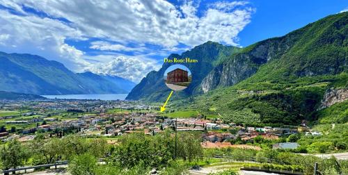 a kite flying over a village in a mountain valley at Das Rote Haus in Riva del Garda