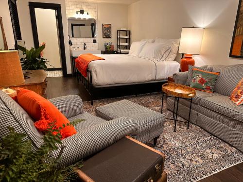 a living room with a couch and a bed at The Boardwalk Hotel in Saint Ignace