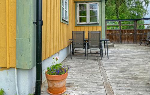 a patio with chairs and a table and a flower pot at Cozy Home In Tranås With Kitchen in Tranås