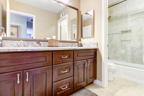 a bathroom with a sink and a tub and a toilet at The Sanctuary in Laguna Hills