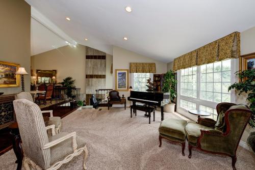 a living room with a grand piano and chairs at The Sanctuary in Laguna Hills