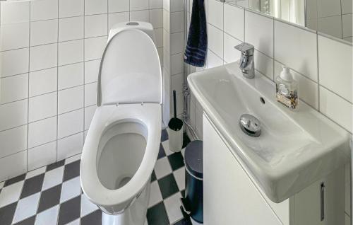 a bathroom with a white toilet and a sink at 1 Bedroom Cozy Home In Flen in Flen