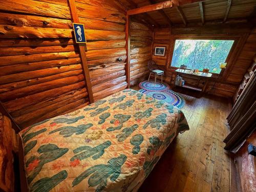 a bedroom with a bed in a wooden cabin at Beehouse Mandala in Guarne