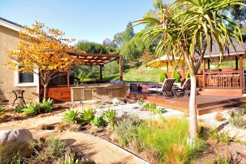 a backyard with a wooden deck and a palm tree at The Sanctuary in Laguna Hills