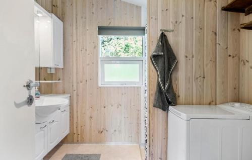 a bathroom with a washing machine and a window at Pet Friendly Home In Jerup With Wifi in Jerup