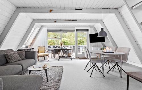 a living room with a couch and a table at Nice Home In Farsø With Kitchen in Farsø