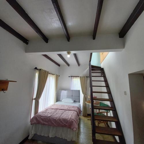a bedroom with a bed and a staircase in a room at Chrysant Huis Villa Istana Bunga in Bandung