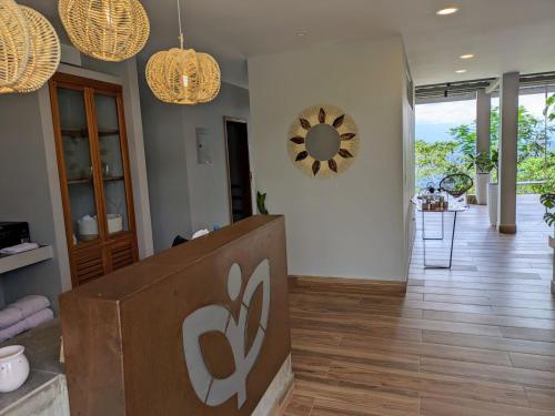 a living room with a sign on the wall at Vibra Healing Lodge y Spa in Teniente Hugo Ortiz