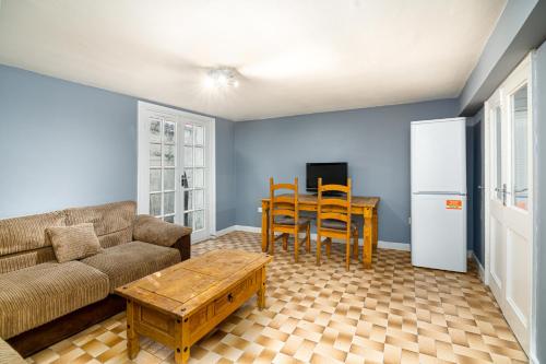 a living room with a couch and a table at Fantastic House New Refurbished in London