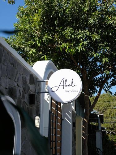 a sign for a gate at a house at Aboli Homestay in Phan Thiet