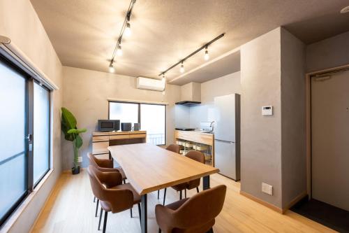 a kitchen and dining room with a wooden table and chairs at ふうろう Furo in Tokyo