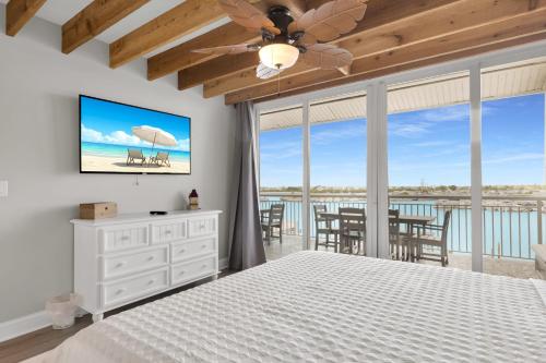 a bedroom with a bed and a view of the ocean at St Kitts - Downtown Waterfront Penthouse Pool Dock Parking in Key West