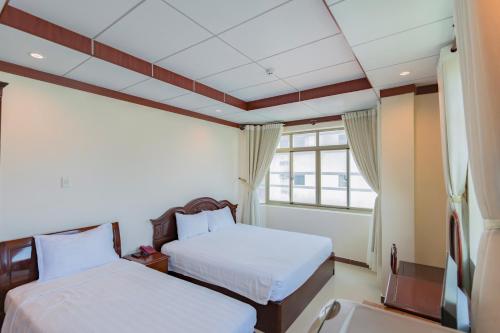 Säng eller sängar i ett rum på Phúc Đạt Hotel
