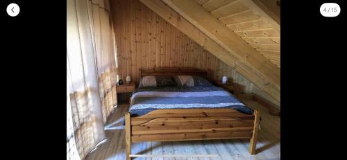 a bedroom with a bed in a wooden attic at Glamping Off-Grid Karlovy Vary in Bochov