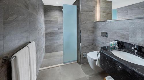 a bathroom with a sink and a toilet at Holiday Inn Tabuk by IHG in Tabuk