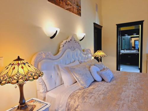 um quarto com uma cama branca e 2 candeeiros em Summer Express Kelowna B&B - Villa Bellissimo Fran-Talia em Kelowna