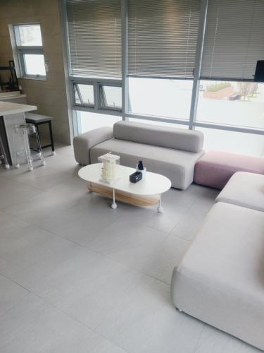 a living room with a couch and a coffee table at Elephant in Busan